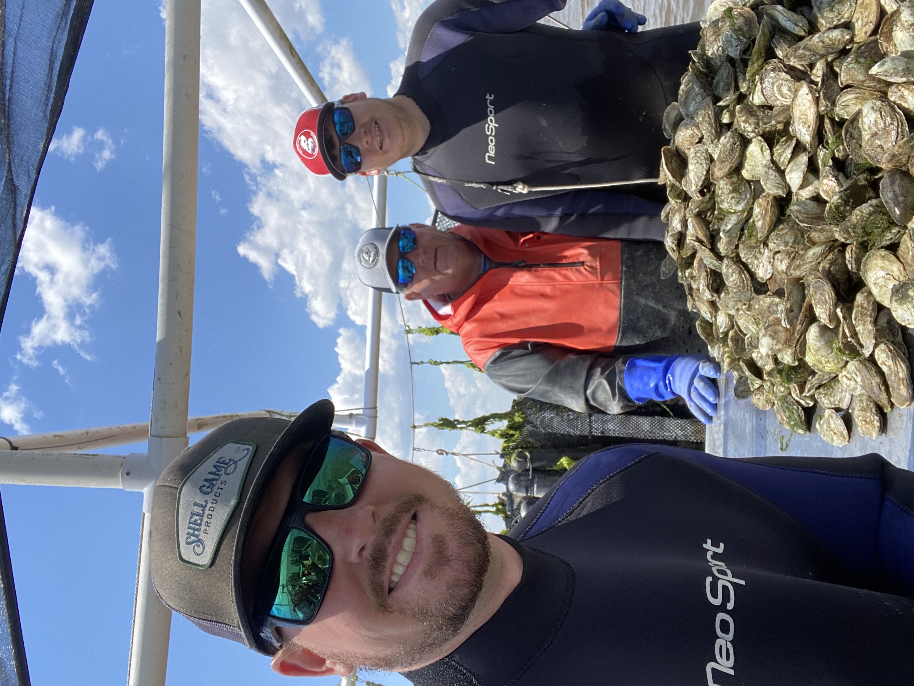 Currituck Oyster Company team with fresh oysters